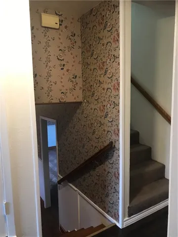a kitchen with granite countertop wood cabinets stainless steel appliances and a sink