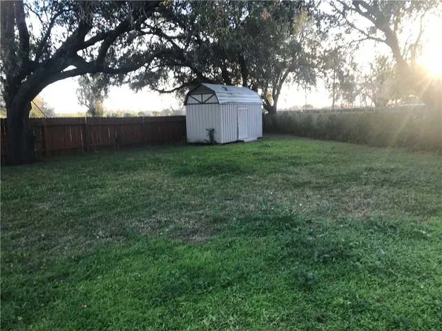a white house that has tree in front of it