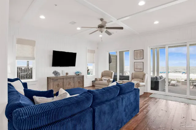 a large kitchen with stainless steel appliances kitchen island granite countertop a dining table chairs and white cabinets