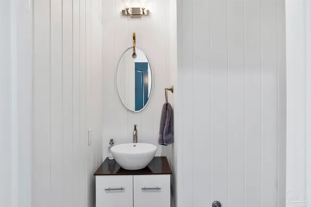 a living room with furniture a chandelier and a wooden floor