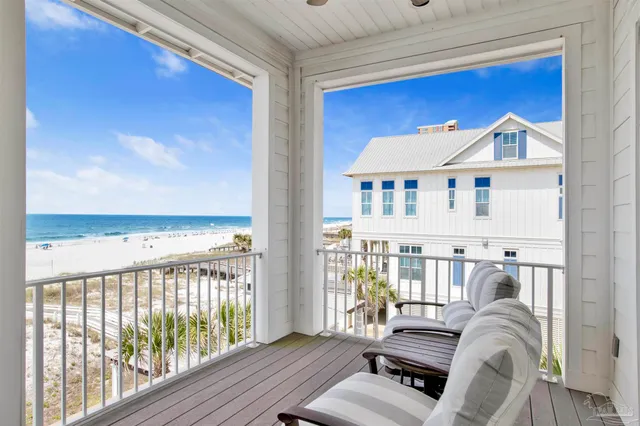 a bedroom with a bed a couch and a flat screen tv