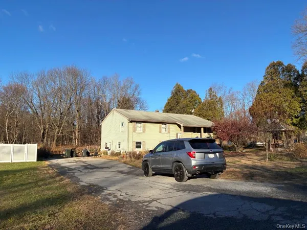 a view of a car park in front of a house