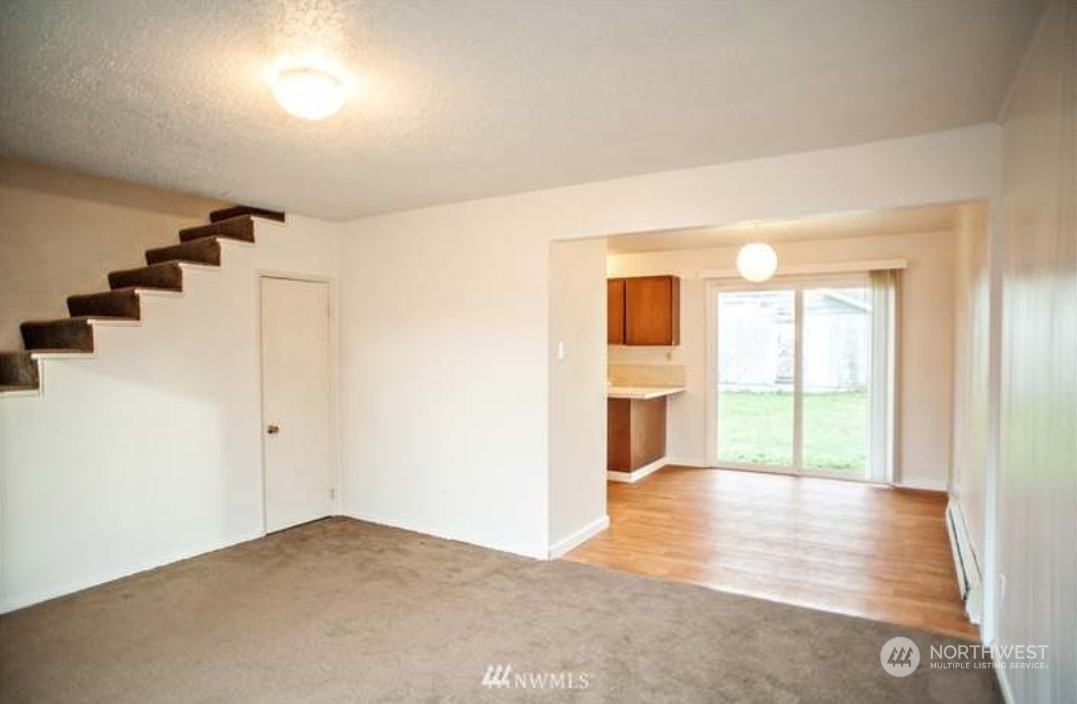 7 Neilton Lane Neilton, WA 98552 - Photo 5 of 11 a view of an empty room with wooden floor and windows