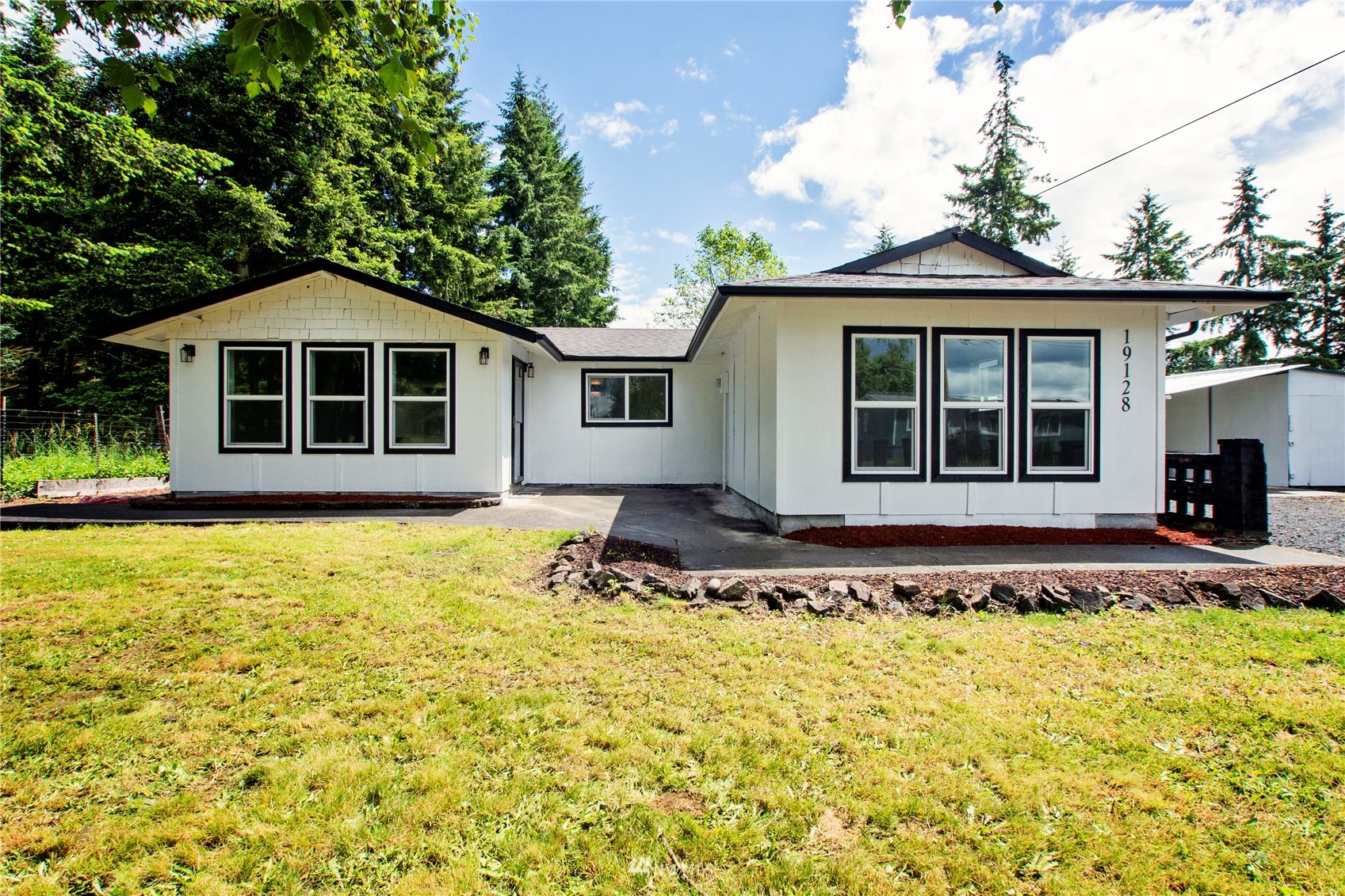 19128 Pecan Street Southwest Rochester, WA 98579 - Photo 1 of 31 a front view of a house with a garden