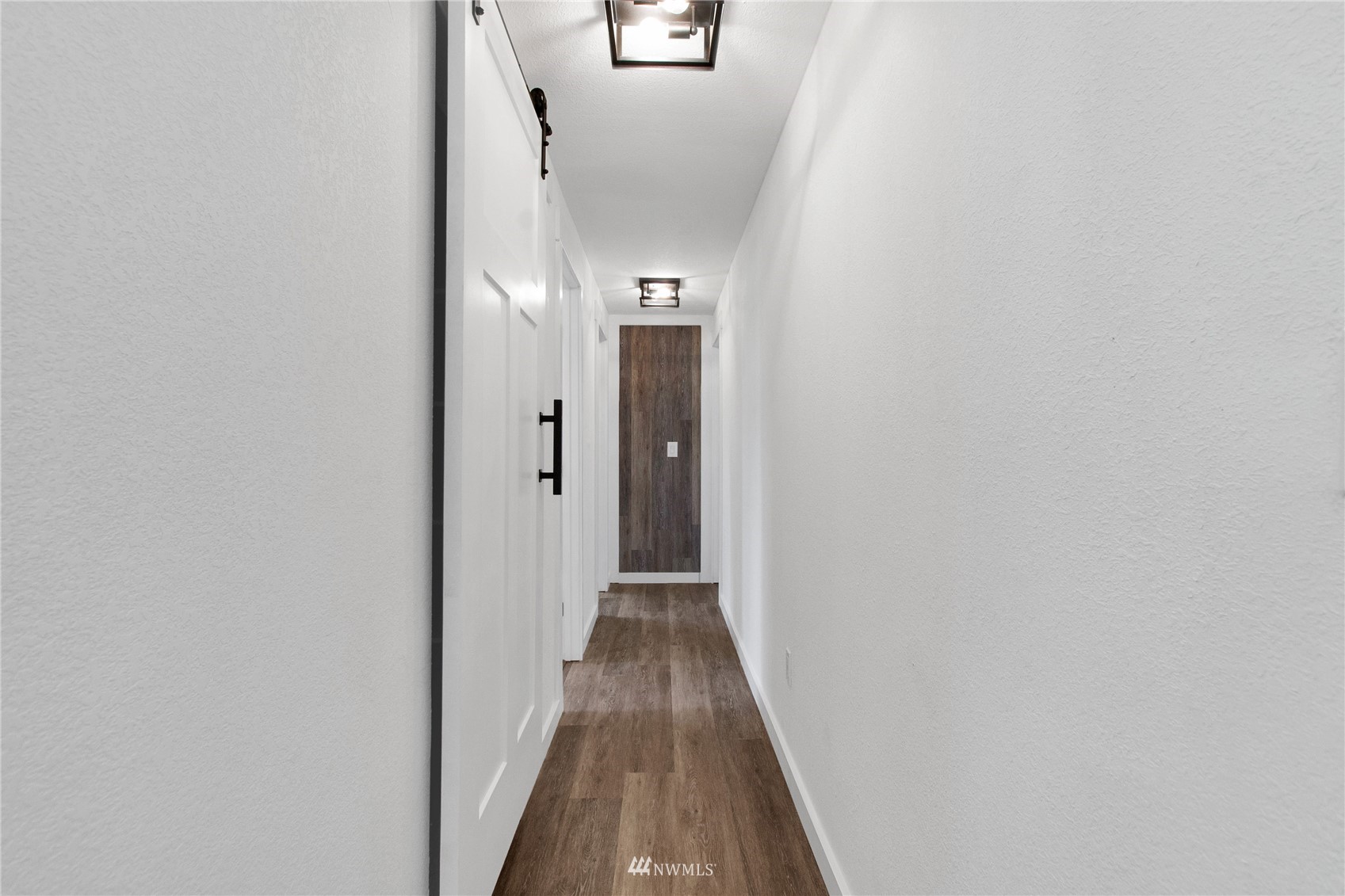 19128 Pecan Street Southwest Rochester, WA 98579 - Photo 11 of 31 a view of a hallway with wooden floor