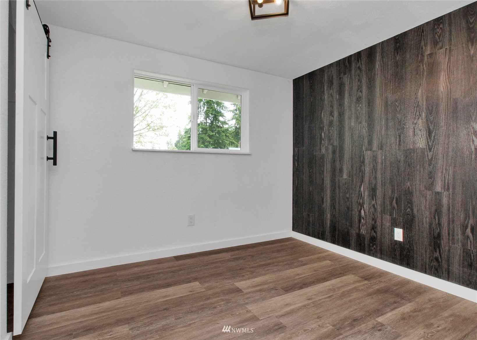 19128 Pecan Street Southwest Rochester, WA 98579 - Photo 18 of 31 a view of an empty room with wooden floor and a window