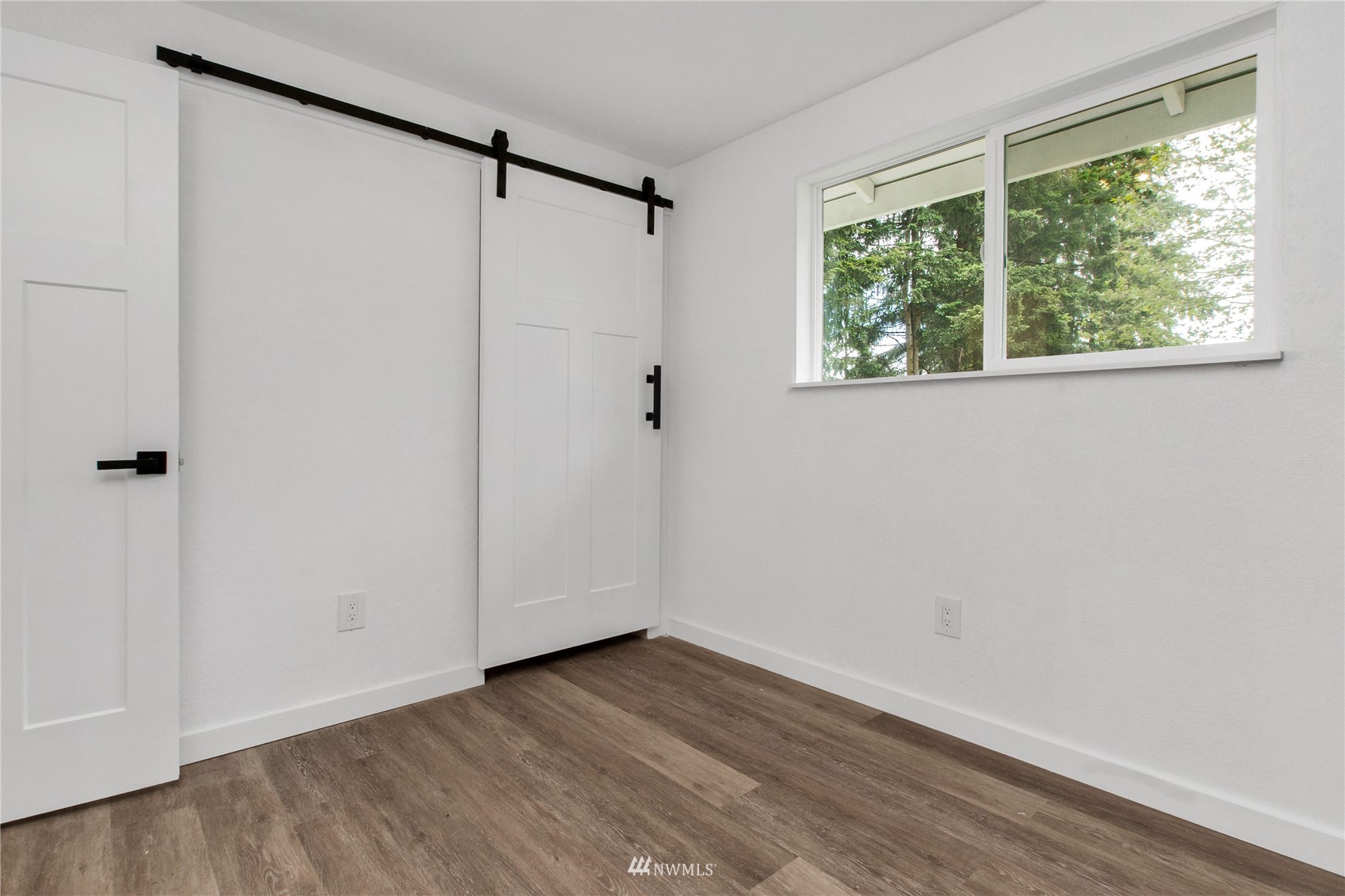19128 Pecan Street Southwest Rochester, WA 98579 - Photo 19 of 31 a view of an empty room with wooden floor and a window