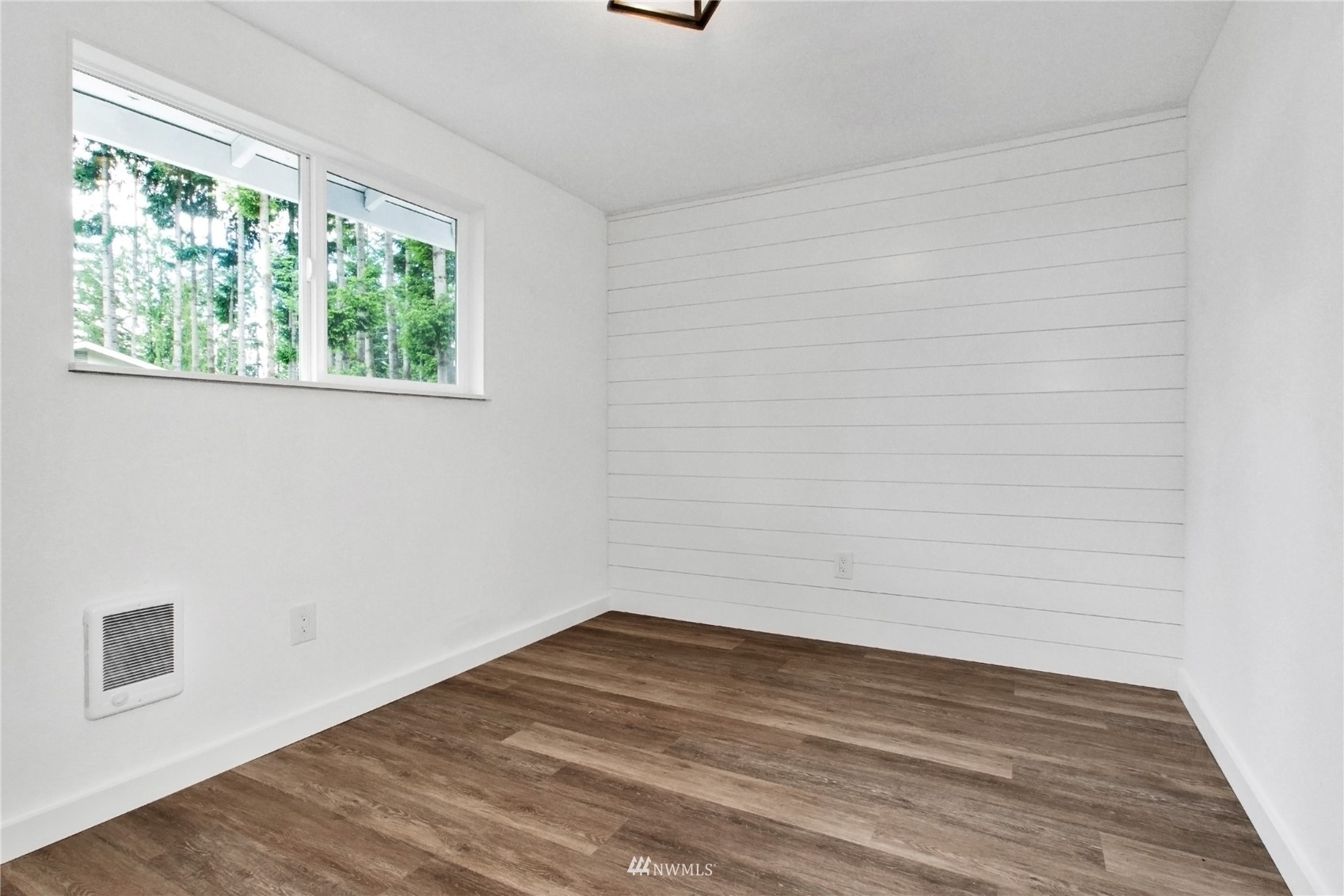 19128 Pecan Street Southwest Rochester, WA 98579 - Photo 20 of 31 a view of a room that has wooden floor and a window