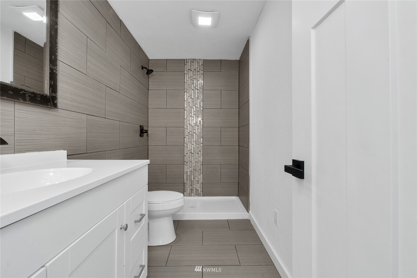 19128 Pecan Street Southwest Rochester, WA 98579 - Photo 22 of 31 a bathroom with a sink a toilet a mirror and shower