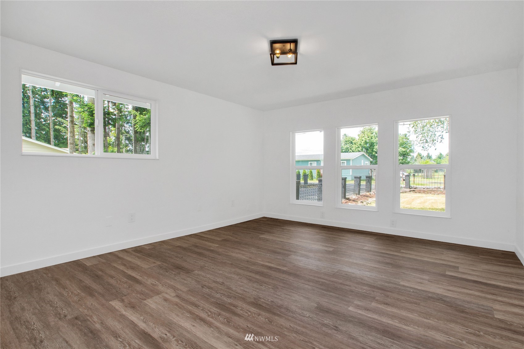 19128 Pecan Street Southwest Rochester, WA 98579 - Photo 23 of 31 a view of an empty room with wooden floor and a window
