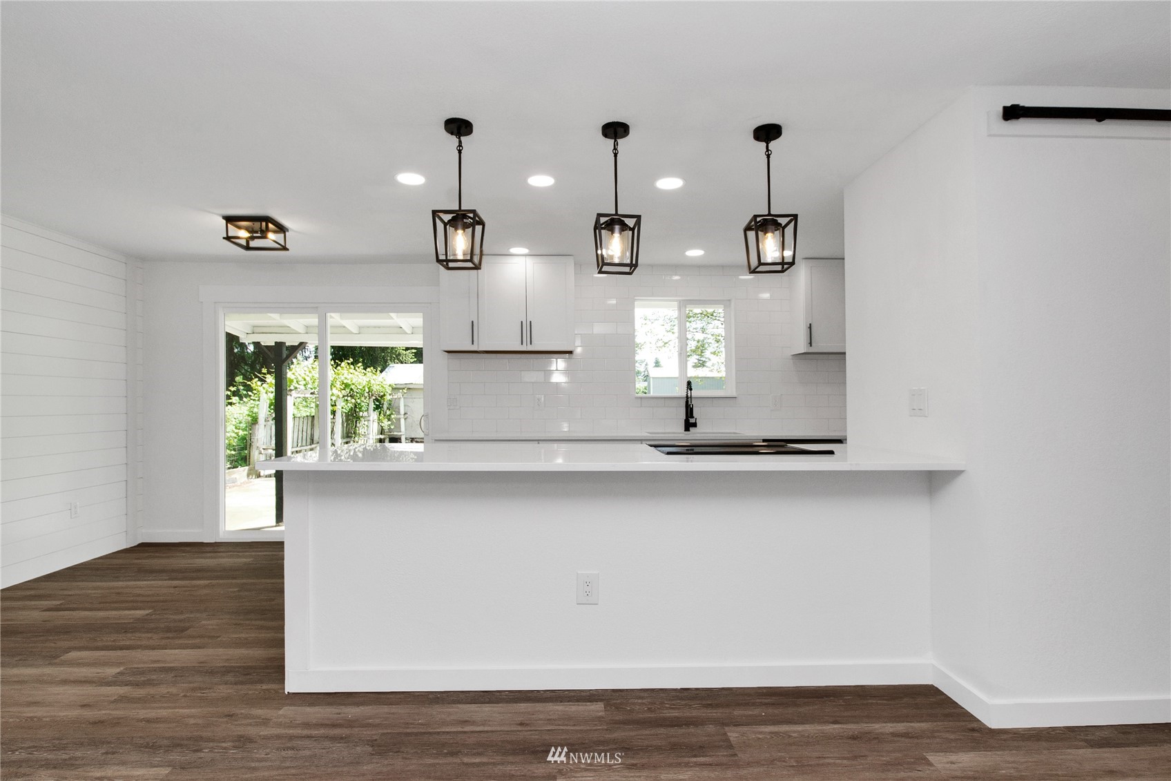 19128 Pecan Street Southwest Rochester, WA 98579 - Photo 5 of 31 a kitchen with a sink and wooden floor
