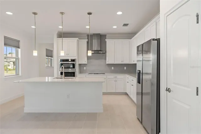 a open kitchen with white cabinets and stainless steel appliances