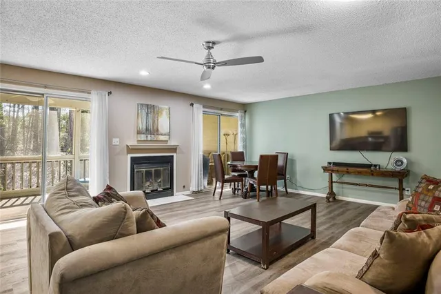 a living room with furniture a flat screen tv and a fireplace