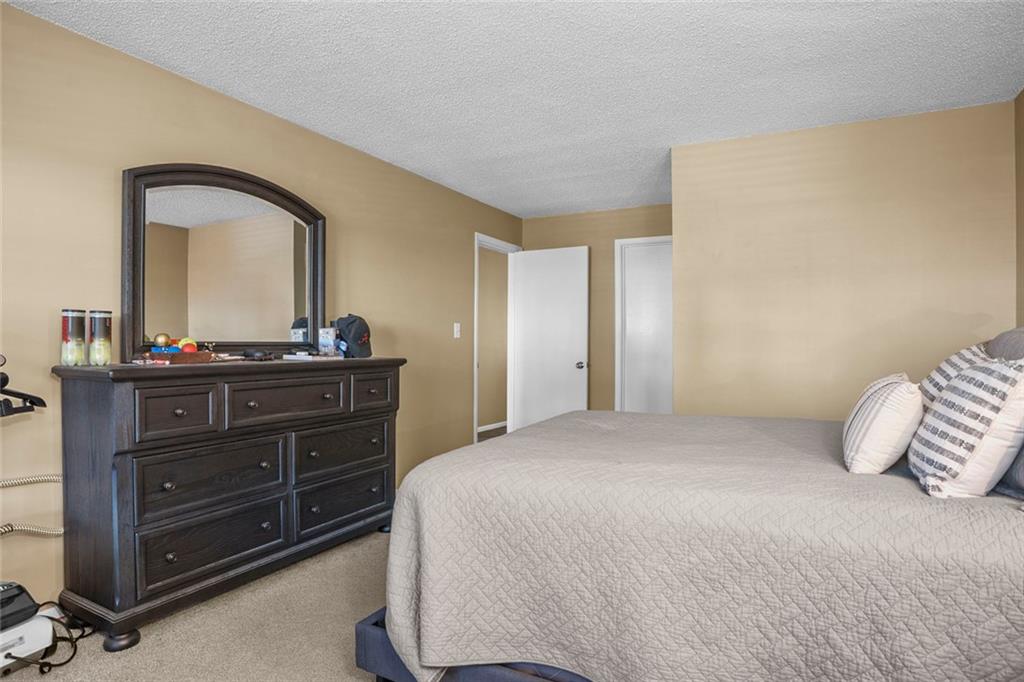 32 Springhedge Ct Street Smyrna, GA 30080 - Photo 12 of 29 a bedroom with a bed and a dresser