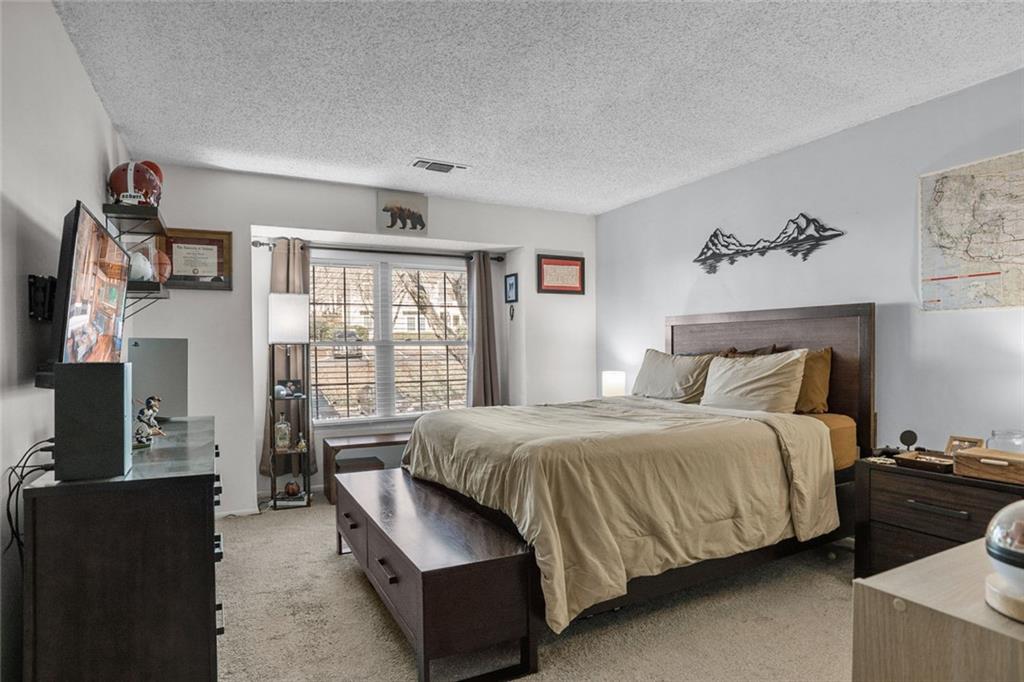 32 Springhedge Ct Street Smyrna, GA 30080 - Photo 14 of 29 a bedroom with a bed and a flat screen tv