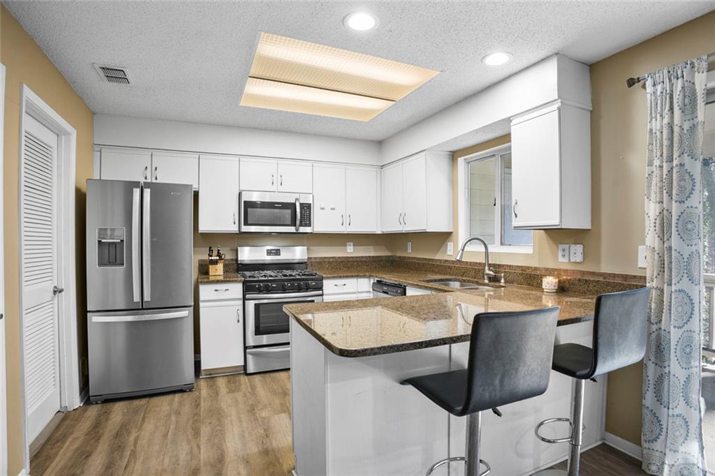 32 Springhedge Ct Street Smyrna, GA 30080 - Photo 2 of 29 a kitchen with kitchen island a sink stove and refrigerator
