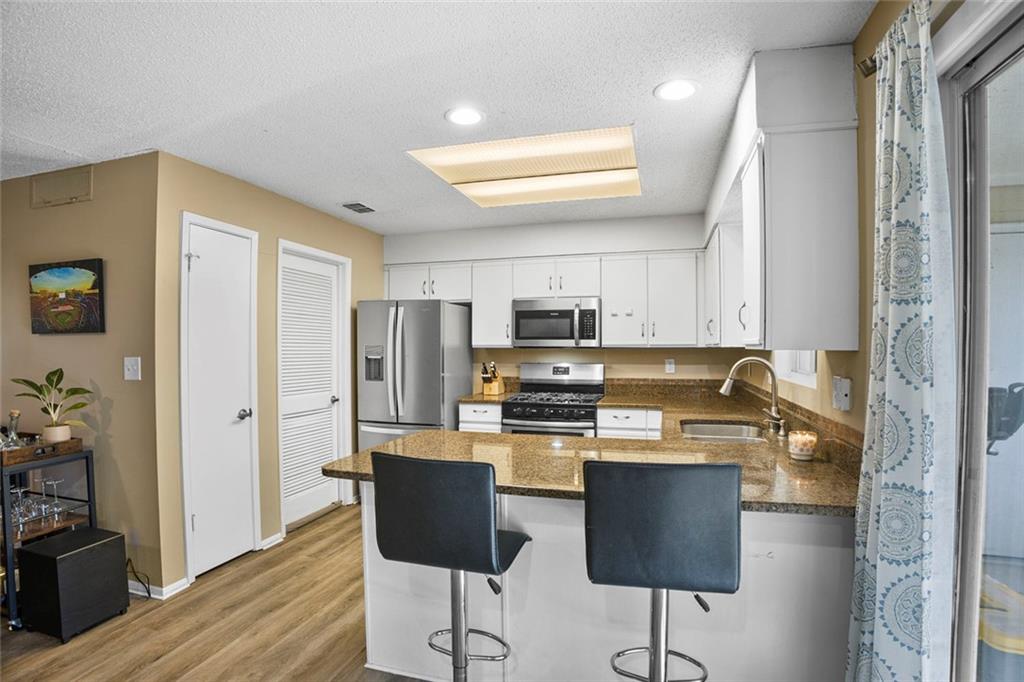 32 Springhedge Ct Street Smyrna, GA 30080 - Photo 9 of 29 a kitchen with stainless steel appliances granite countertop a refrigerator and a stove top oven