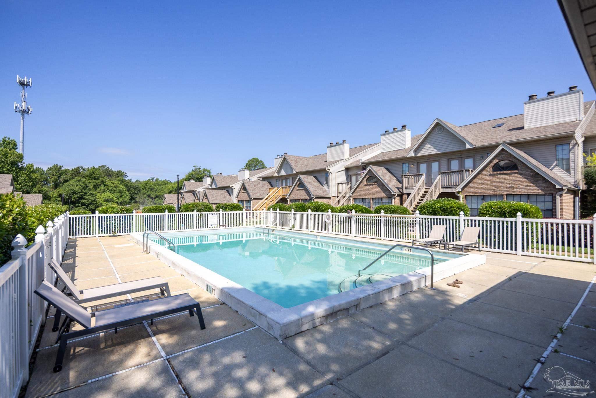 7150 Plantation Road, Unit 312 Pensacola, FL 32504 - Photo 12 of 14 a view of a swimming pool with a lounge chairs