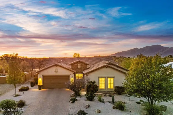 a view of a big house with a mountain in the background