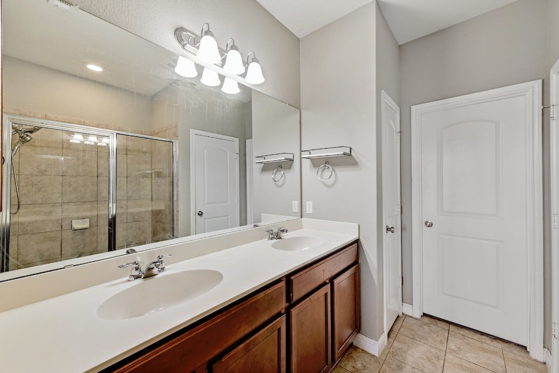 10104 Wading Pool Path Austin, TX 78748 - Photo 13 of 25 a bathroom with a sink double vanity and a mirror
