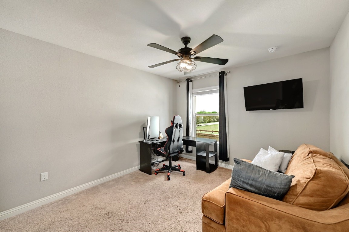 10104 Wading Pool Path Austin, TX 78748 - Photo 20 of 25 a living room with furniture and a flat screen tv