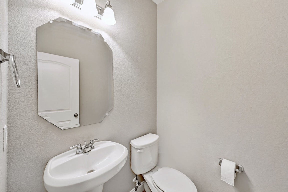 10104 Wading Pool Path Austin, TX 78748 - Photo 21 of 25 a bathroom with a sink mirror and toilet