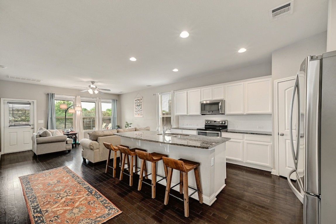 10104 Wading Pool Path Austin, TX 78748 - Photo 5 of 25 a large kitchen with kitchen island a dining table and chairs