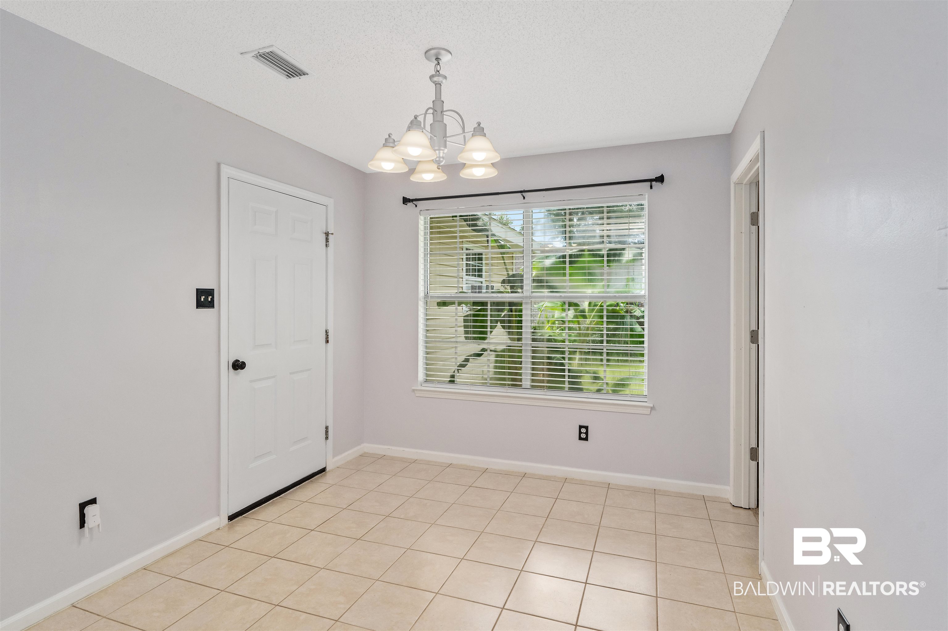 25779 Austin Road Daphne, AL 36526 - Photo 29 of 30 Spare room featuring a chandelier and baseboards