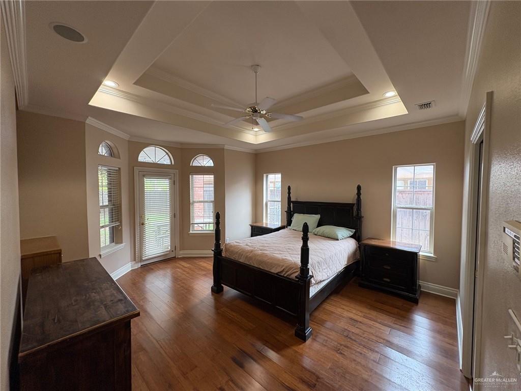 336 Toucan Avenue McAllen, TX 78504 - Photo 14 of 34 a bedroom with a large bed and a chandelier