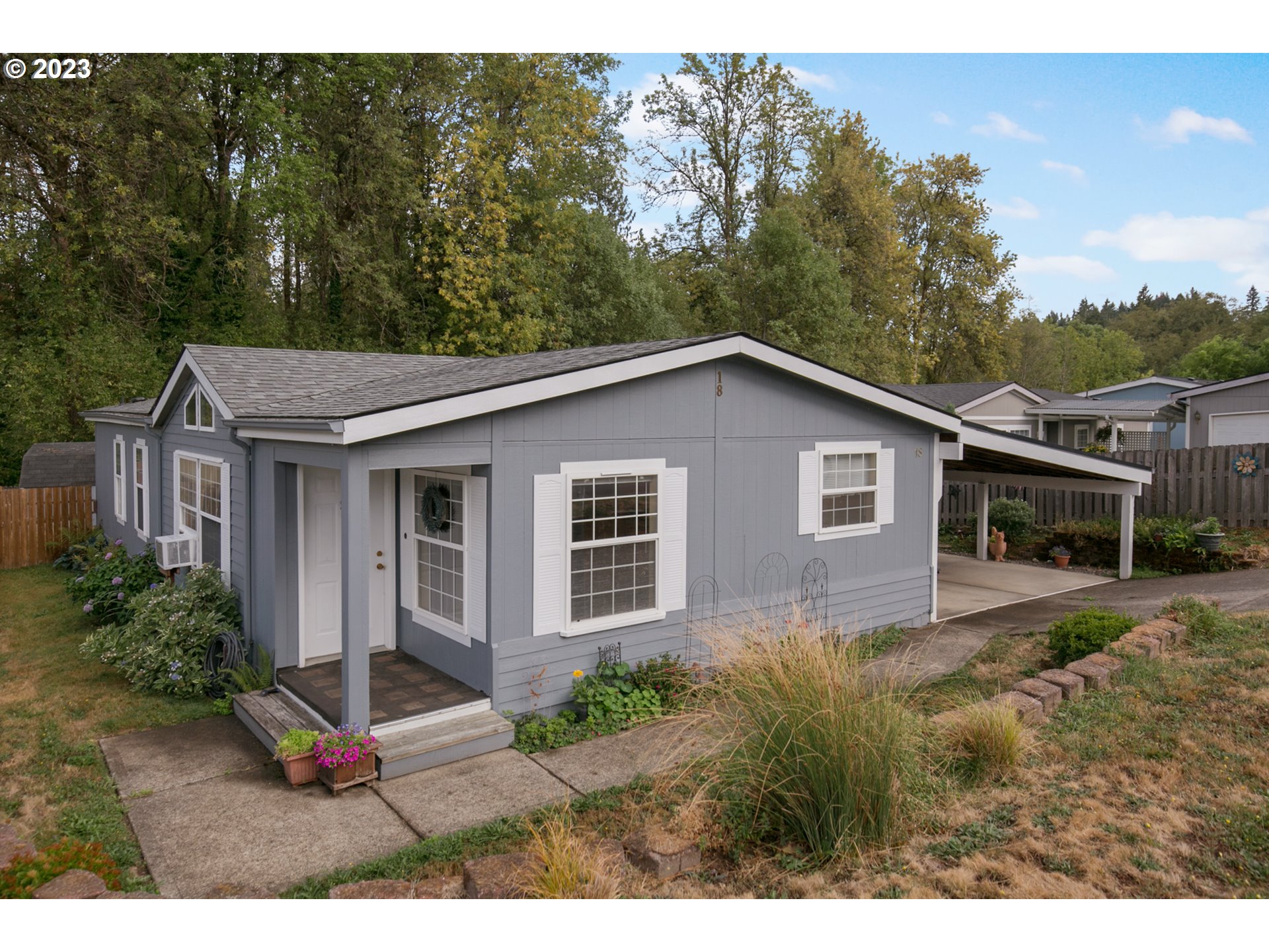 18 South Gee Creek Loop Ridgefield, WA 98642 - Photo 1 of 24 a view of a yard in front of a house with large trees