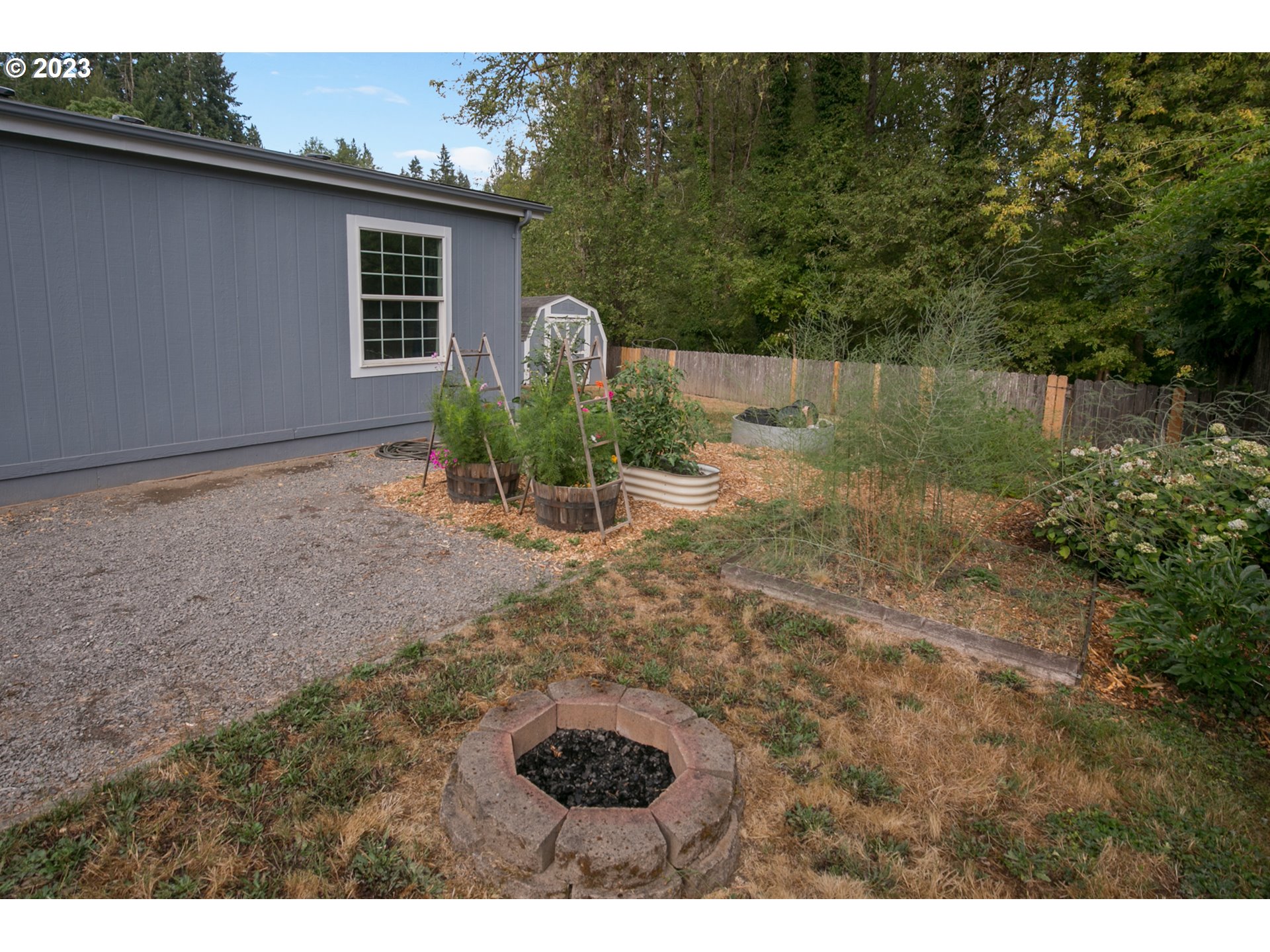 18 South Gee Creek Loop Ridgefield, WA 98642 - Photo 22 of 24 a backyard of a house with barbeque oven fire pit table and chairs