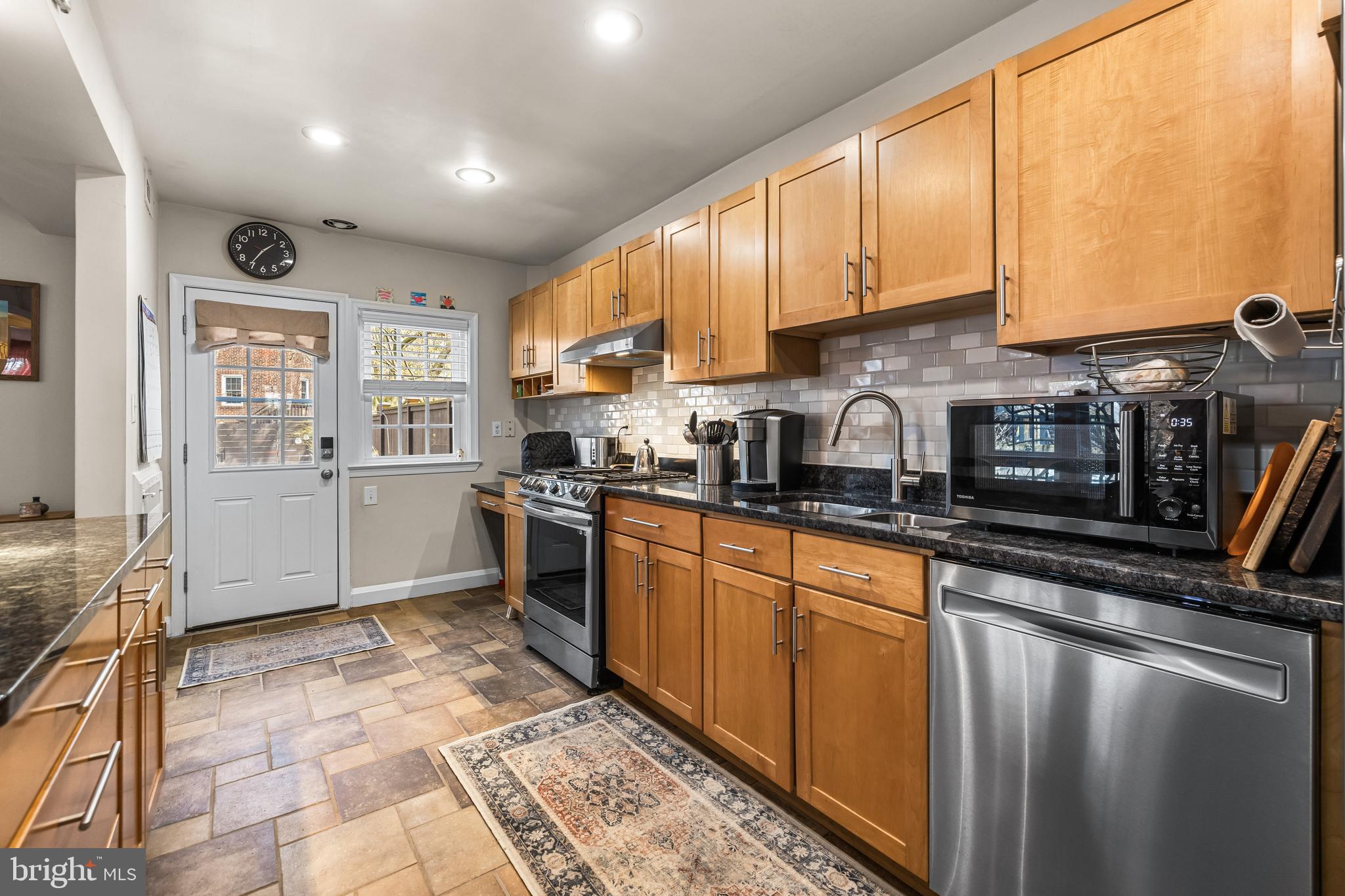 6447 Blenheim Road Baltimore, MD 21212 - Photo 13 of 51 a kitchen with stainless steel appliances granite countertop a stove sink and cabinets