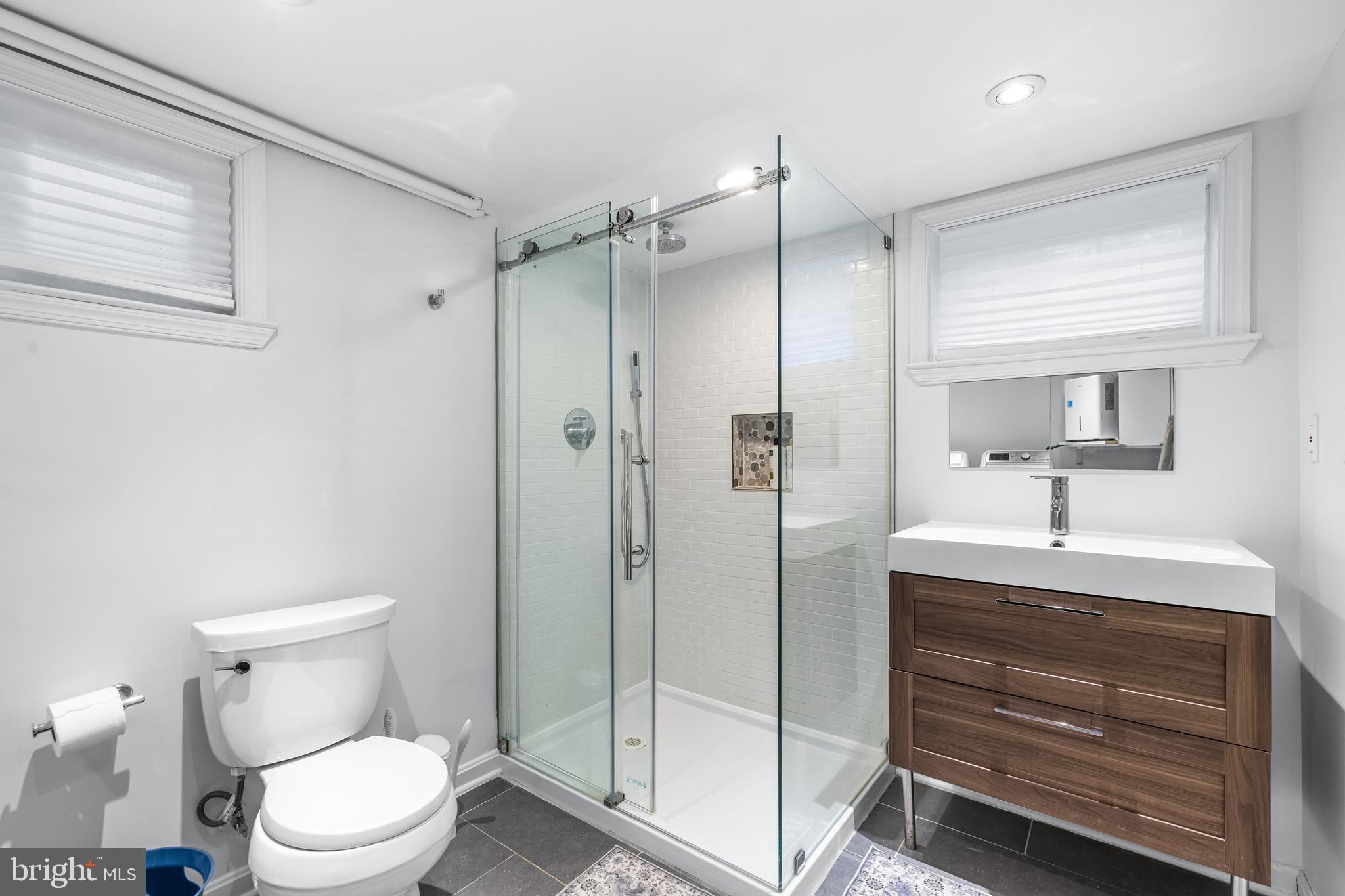 6447 Blenheim Road Baltimore, MD 21212 - Photo 40 of 51 a bathroom with a toilet a sink and shower
