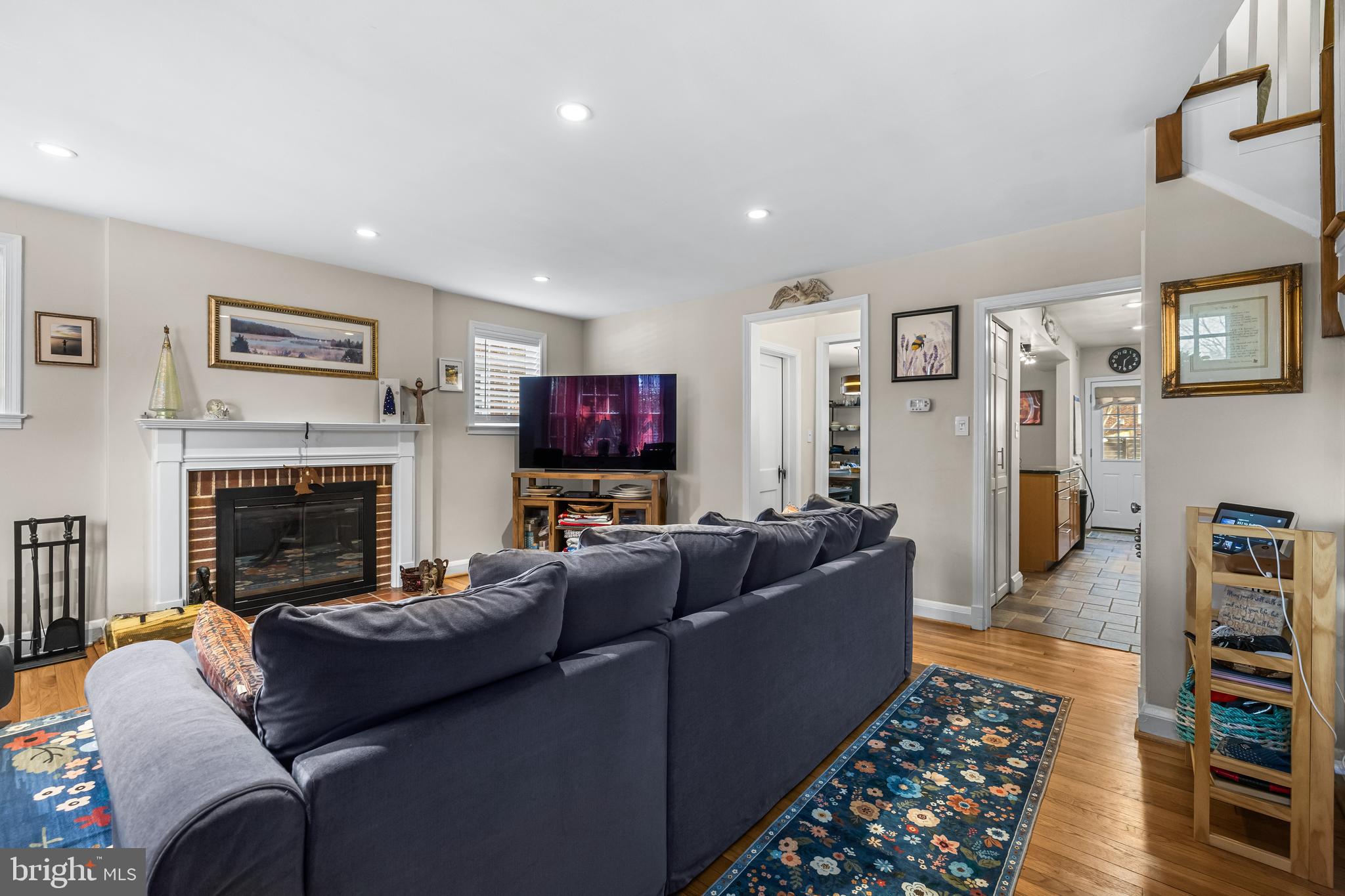 6447 Blenheim Road Baltimore, MD 21212 - Photo 6 of 51 a living room with furniture a flat screen tv and a fireplace