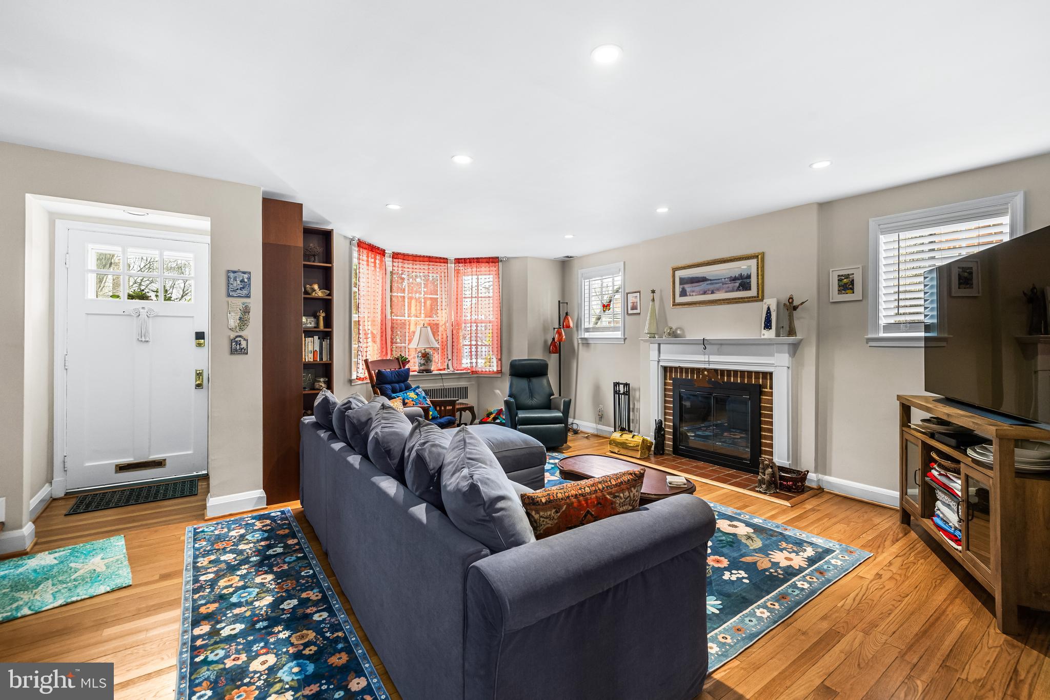 6447 Blenheim Road Baltimore, MD 21212 - Photo 7 of 51 a living room with furniture a flat screen tv and a fireplace