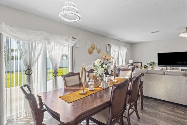 a view of a dining room with furniture window and outside view