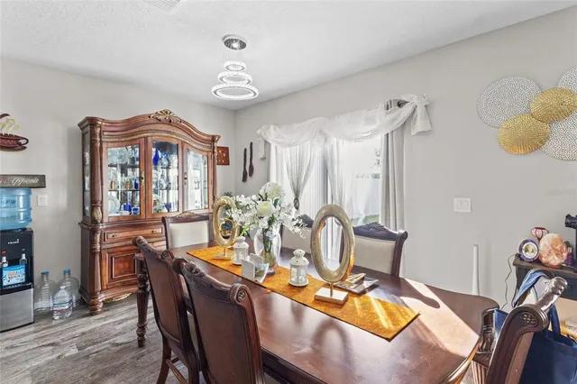 a view of a dining room with furniture and chandelier