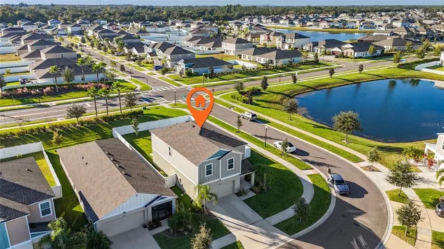 an aerial view of a pool a yard and outdoor seating