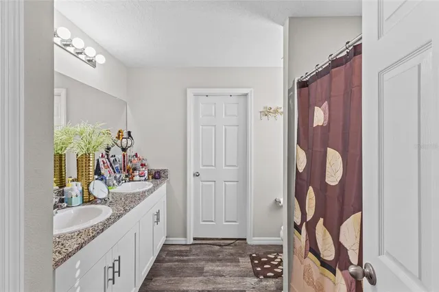 a bathroom with a sink toilet and a mirror