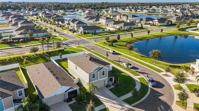 an aerial view of residential houses with outdoor space and swimming pool