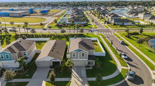 an aerial view of residential houses with yard