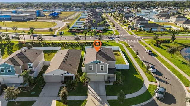 an aerial view of residential houses with outdoor space and swimming pool