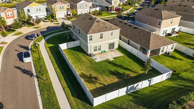 an aerial view of residential house with outdoor space and swimming pool