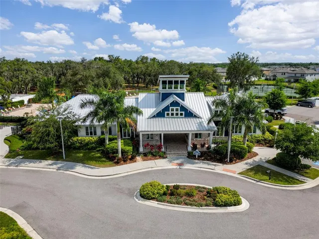 an aerial view of a house with swimming pool patio and outdoor seating