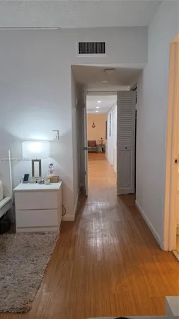 a bedroom with a bed window and dresser