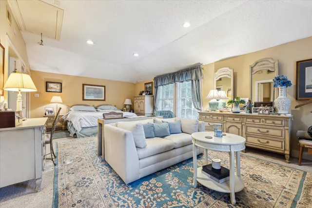 a living room with furniture a rug and a window
