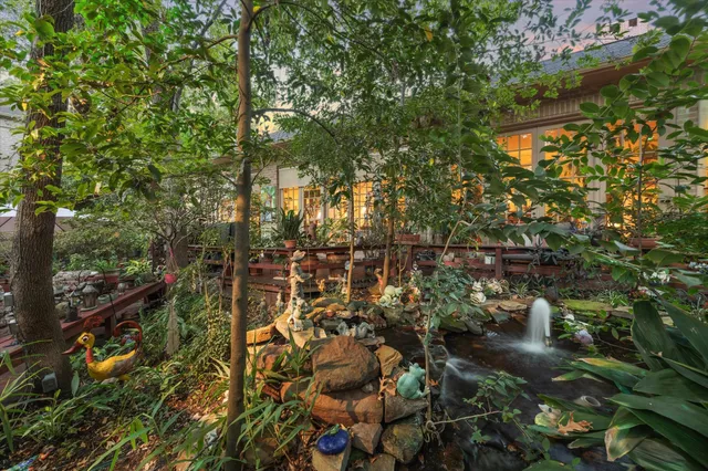 a patio with tables and chairs and a umbrella