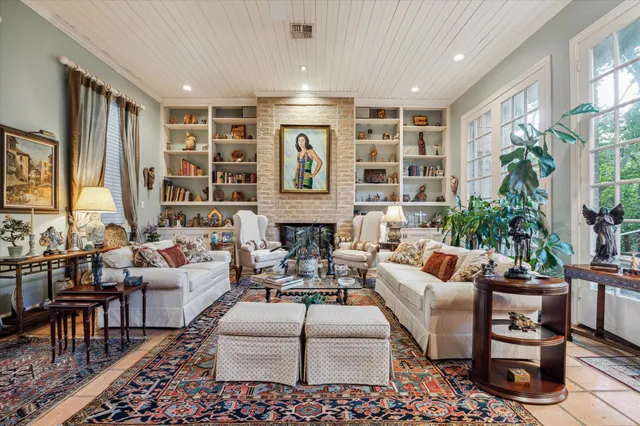 a living room with furniture potted plant and large window