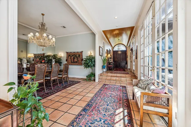 a view of a dining room with furniture and chandelier