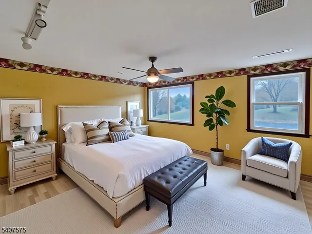 a bedroom with a bed couch and painting on the wall